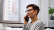 © woff - Woman speaking on the phone in a bright room