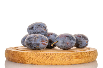 Black ripe plums with home accessories isolated on white background, close-up.