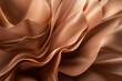 © lashkhidzetim - close up of a piece of fabric with a brownish color. The fabric is folded and has a wavy texture. Concept of luxury and elegance, as the fabric appears to be made of high-quality material