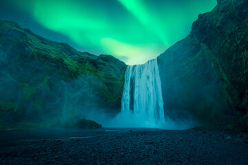 Wall Mural - aurora borealis over famous skogafoss waterfall on skoga river, iceland. gorgeous icelandic landscap