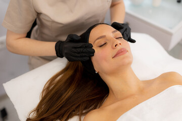 Relaxation and rejuvenation during a soothing facial treatment at a serene spa in the afternoon light