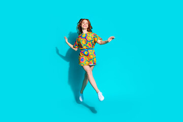 Wall Mural - Full length photo of lovely young lady jump walking dressed stylish colorful garment isolated on cyan color background