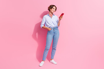 Wall Mural - Full length portrait of stunning nice person hold use smart phone texting isolated on pink color background