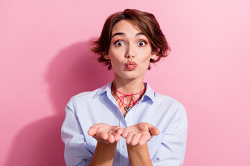 Wall Mural - Portrait of lovely gorgeous person pouted lips hands palms send you air kiss isolated on pink color background