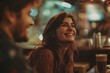 © Aodsy - Happy woman smiling brightly while enjoying drinks with a friend in a cozy café atmosphere with warm lighting and a vibrant, relaxed vibe