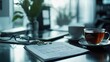 © peeter - A professional display of a balance sheet and tax documents on a stylish desk, with a cup of tea beside them.