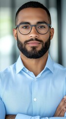 Wall Mural - A man with a beard and glasses standing with his arms crossed