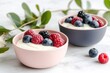 © Aliaksandra - seasonal food display, pastel bowls filled with spring yogurt and fresh berries sit on a farmhouse table with spring decorations and greenery