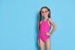 © New Africa - Happy girl in beachwear on light blue background, space for text