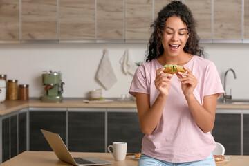 Poster - African-American woman with tasty eclair in kitchen