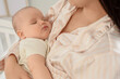 © Pixel-Shot - Mother with her sleeping baby in bedroom, closeup