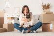 © Pixel-Shot - Pretty young woman with French bulldog and cardboard boxes at home