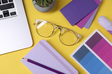 Poster - Designer's workplace. Flat lay composition with stationery and laptop on yellow background