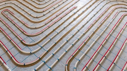 Fototapete - An overhead view of partially laid pipes intertwining and spiraling in a rhythmic pattern with thin layers of insulation visible along the edges indicating the careful planning of