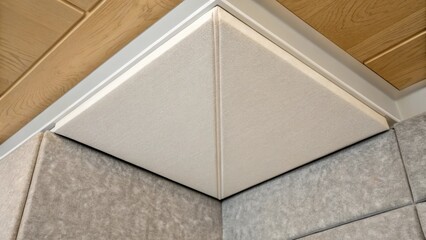 Aufkleber - An extreme closeup of a single corner where an acoustic panel slightly separates from the ceiling emphasizing the clean lines of the installation amidst the rough edges of existing