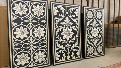 Aufkleber - A collection of black and white patterned wall panels exudes elegance with intricate floral motifs contrasting sharply against the stark color scheme.
