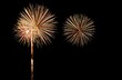 © Maryna - Golden fireworks explode brilliantly against dark night sky. Festive display bursts with light, color. Celebratory event like New Year Eve 4th of July. Sparkling gold fireworks create stunning visual