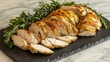 © isrofiyah - A whole roasted chicken carved into elegant slices, arranged artistically on a slate serving platter with fresh herbs
