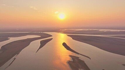 Sticker - Dry season golden lake at sunset showing the texture of the earth