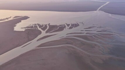 Sticker - Dry season golden lake at sunset showing the texture of the earth