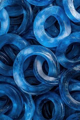 Poster - Close-Up View of Glossy Blue Rings on a Textured Background