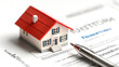 © นิโลบล ชํานาญธรรม - mortgage document with small house model and pen, symbolizing home ownership