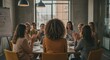 © Laki - Group Meeting with Professional Women in Office Setting, Back View of Curly-Haired