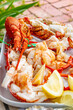 © andrewbalcombe - boiled rock lobster crayfish served with lemon wedges on a platter