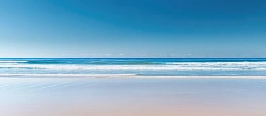 Poster - serene blurred blue ocean waves under clear sky with vast copy space for text and creative designs