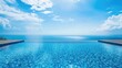 © The 2R Artificiality - Tranquil infinity pool with crystal clear blue water reflecting a bright sunny sky and serene ocean view providing ample text space