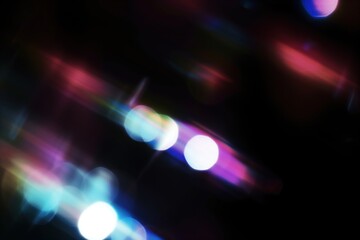 Poster - Abstract light leaks with vibrant color streaks on dark background. Digital art, creative design, futuristic theme, colorful effect. Blurry sparkling particles in the air, festive light effect