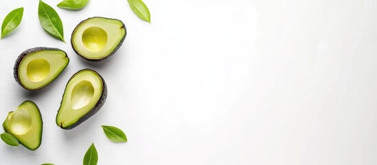 Poster - Fresh avocados and avocado halves arranged on a clean white background with green leaves and ample copy space for your promotional text
