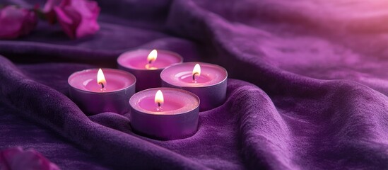 Poster - Glowing Tea Light Candles on Luxurious Purple Velvet Fabric with a Soft Focus Background and Space for Custom Text