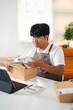© Fahng - Asian couple startup small business owner packing goods for delivery to clients.