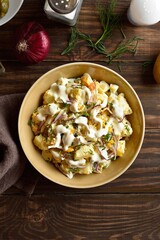 Wall Mural - Warm potato salad with egg, pickle, red onion with mayonnaise an