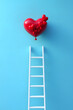 © john - White ladder reaching to heart shaped balloon against blue background