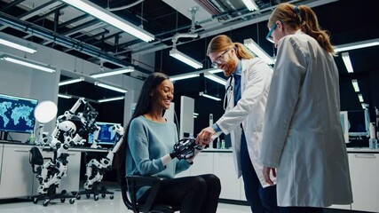 Poster - Medical professionals demonstrate advanced prosthetic technology in a research lab setting with a smiling participant