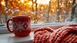 © O - Cozy winter morning with red mug and knitted blanket by snowy window. Merry Christmas. Happy New Year