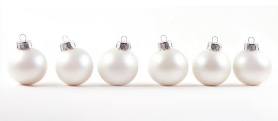 Poster - Elegant white Christmas ornaments arranged in a neat row against a pristine white background for festive seasonal decor themes
