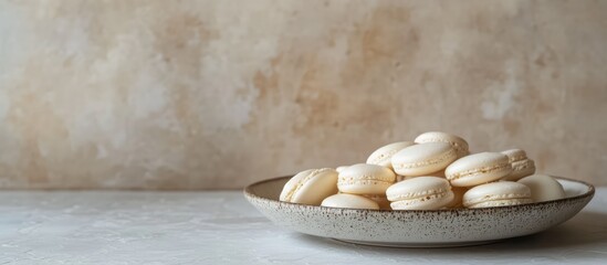 Aufkleber - Delicate white macaroons elegantly displayed on a rustic plate against a soft textured background showcasing bakery artistry.