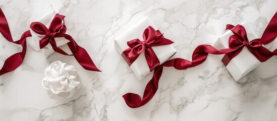 Aufkleber - Elegant white gifts with red ribbons on a white marble surface showcasing a minimalist holiday theme and festive spirit.