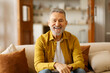 © Home-stock - Portrait of happy older retired man laughing, looking at camera, enjoying video call or distant communicating with friends