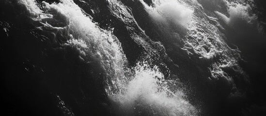 Aufkleber - dynamic black and white water cascade with powerful waves creating splashes and foam in a dramatic flowing river scene