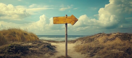 Leinwandbilder - Scenic beach pathway sign directing travelers towards a beautiful coastal destination with a vibrant sky and ocean backdrop.