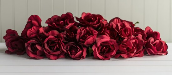 Poster - Close-up of vibrant red roses with dew drops on a white wooden surface showcasing elegance and beauty with ample copy space for text