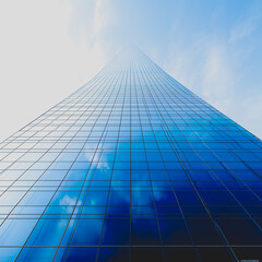 Sticker - A tall building with a blue sky in the background