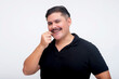 © Mdv Edwards - Man smiling while playfully touching his moustache on white background