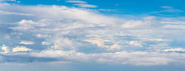 Wall Mural - Blue Sky with Fluffy White Clouds on a Sunny Summer Day. Cloudscape - Blue sky and white clouds. Background cloud summer. Sky cloud clear with sunset. Natural sky