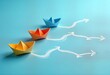 © Pete - Colorful paper boats on blue surface with different movement trajectories. Concept about various ways to achieve goals, effectiveness. Different directions represent different paths to success.