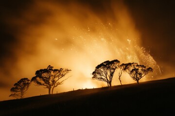 Aufkleber - A dramatic wildfire lights up the night sky, silhouetting a row of trees and creating an intense, stark contrast between nature's beauty and destruction.